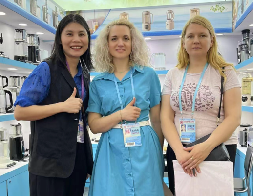 Group photo of Zhongshan Yuekon Electrical Appliances Co., Limited team with international clients during a business meeting, showcasing partnership and collaboration.