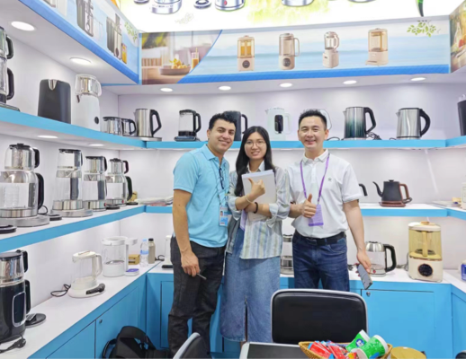 Team members of Zhongshan Yuekon Electrical Appliances Co., Limited posing with international clients, highlighting a successful business partnership.