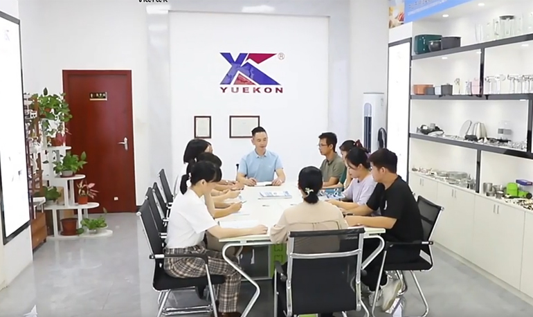 Image of a meeting at Zhongshan Yuekon Electrical Appliances Co., Limited, showing team members engaged in a business discussion.