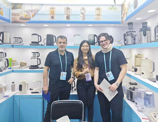 Photo of Zhongshan Yuekon Electrical Appliances Co., Limited staff with international clients, capturing a moment of business cooperation and friendship.
